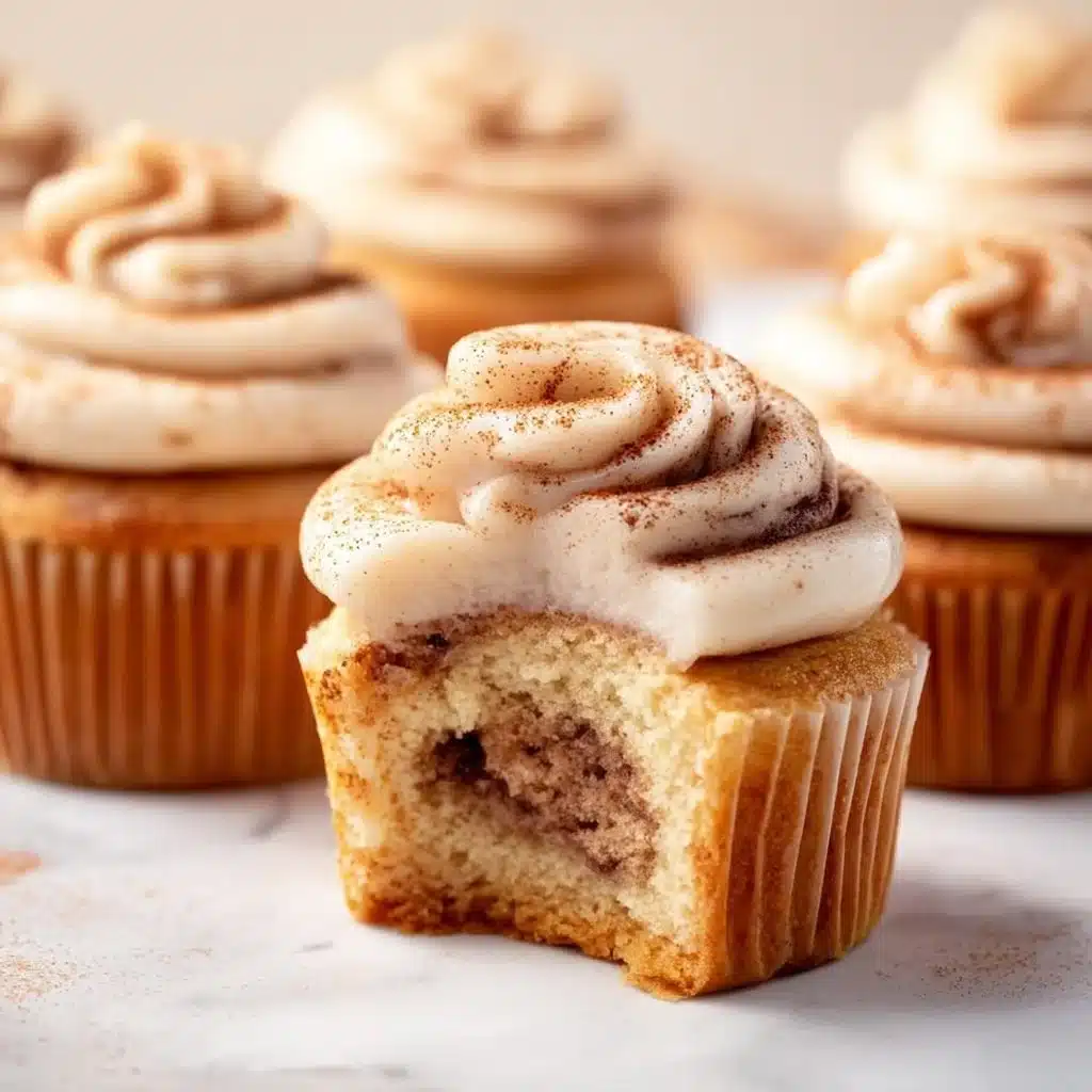 Cinnamon roll cupcakes topped with sweet icing and cinnamon sugar