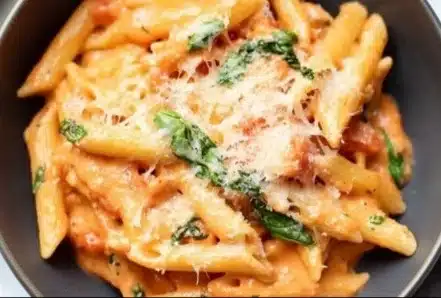 Creamy tomato pasta dish with fresh herbs and parmesan cheese