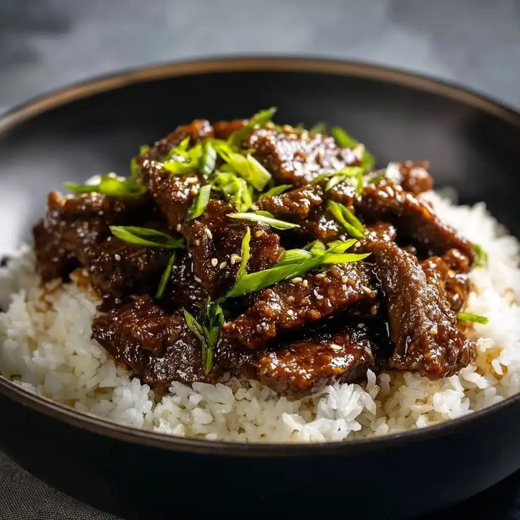 Delicious plate of Mongolian Beef with vibrant vegetables and savory sauce.