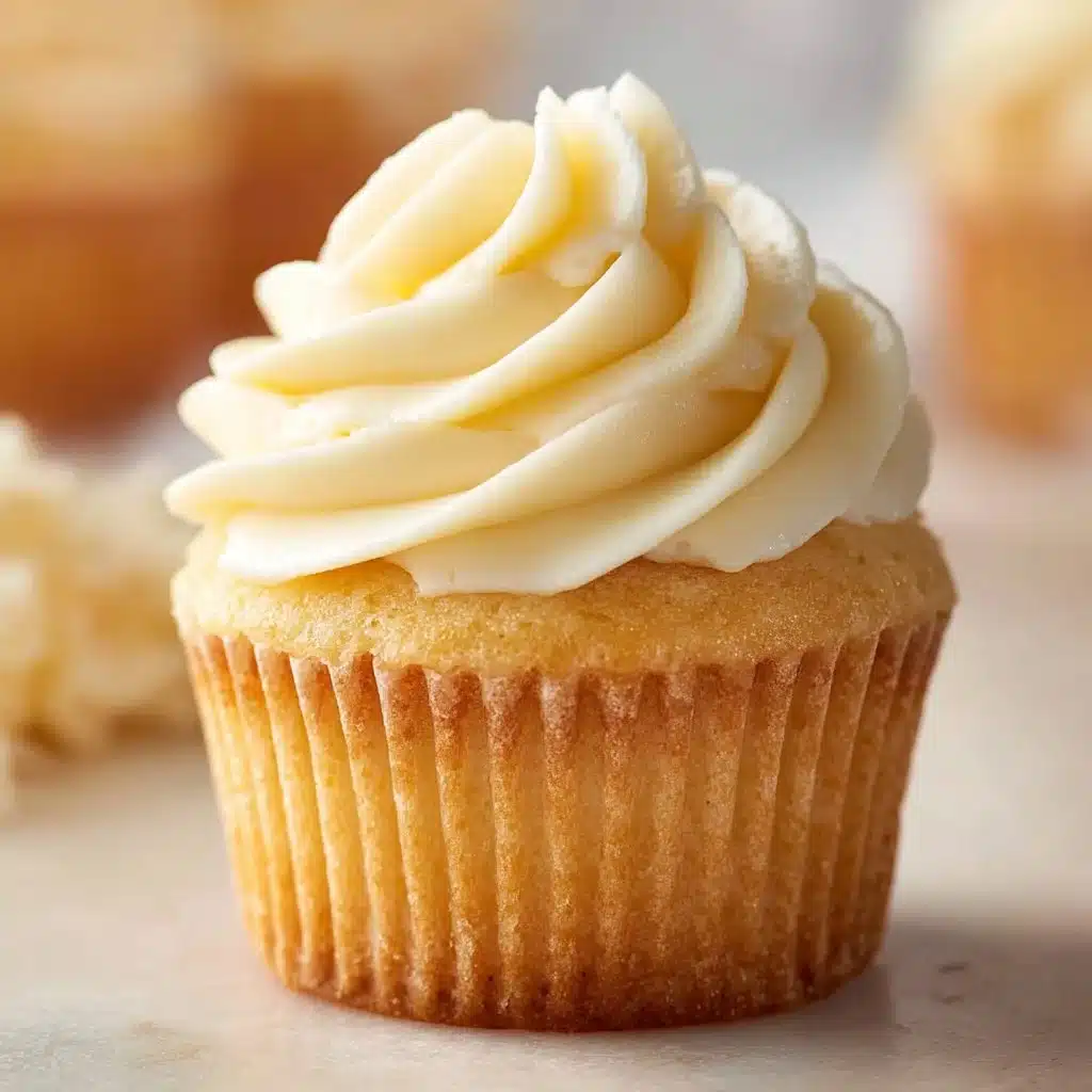 Freshly baked vanilla cupcakes with creamy frosting on a decorative plate
