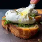 Variety of colorful avocado toast variations with different toppings on bread