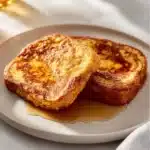 Deliciously golden brown classic French toast served with maple syrup.