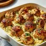 Plate of Greek chicken meatballs with lemon orzo garnished with herbs