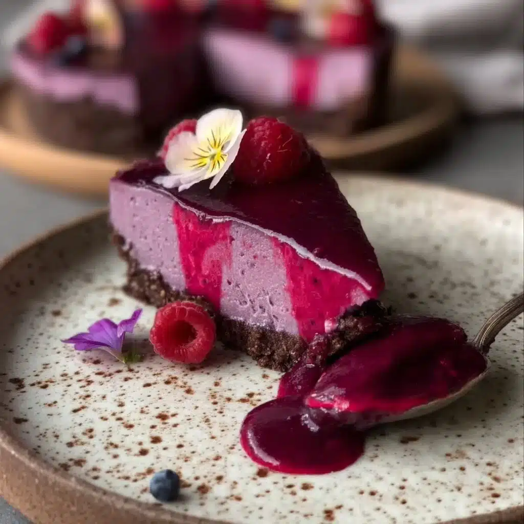 No-bake raspberry tart with hazelnut cacao crust on a wooden table