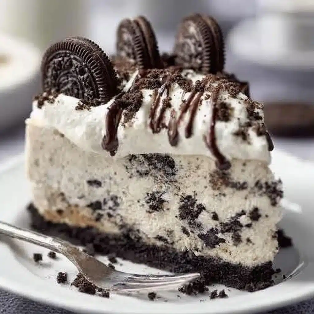 Delicious no-bake Oreo cheesecake topped with crushed Oreos and chocolate ganache.