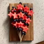 Colorful star-spangled fruit skewers featuring red, white, and blue fruits.