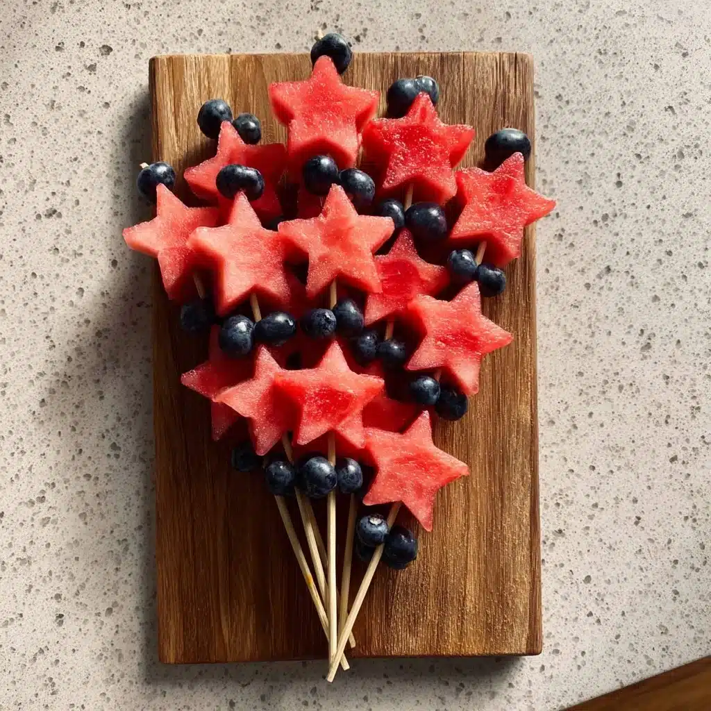 Colorful star-spangled fruit skewers featuring red, white, and blue fruits.